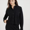 Cashmere knit shirt with shiny tab